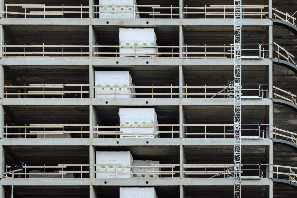 Close-up of a multi-storey building under construction, showcasing steel and concrete structure.