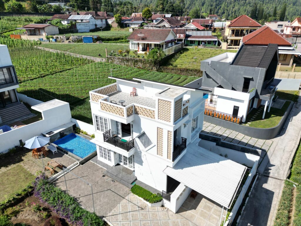 pexels photo 33976206 33976206 Aerial view of a modern house with a pool, located in a scenic hillside neighborhood.